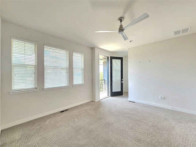 carpeted empty room featuring ceiling fan