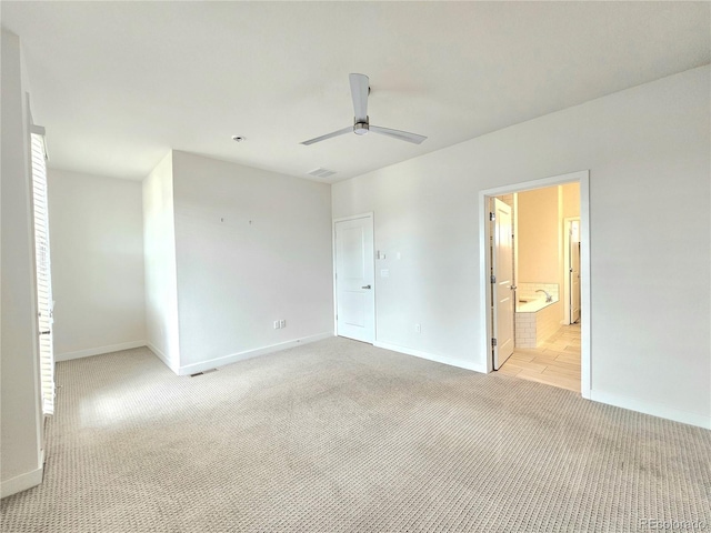 interior space with ceiling fan and light carpet