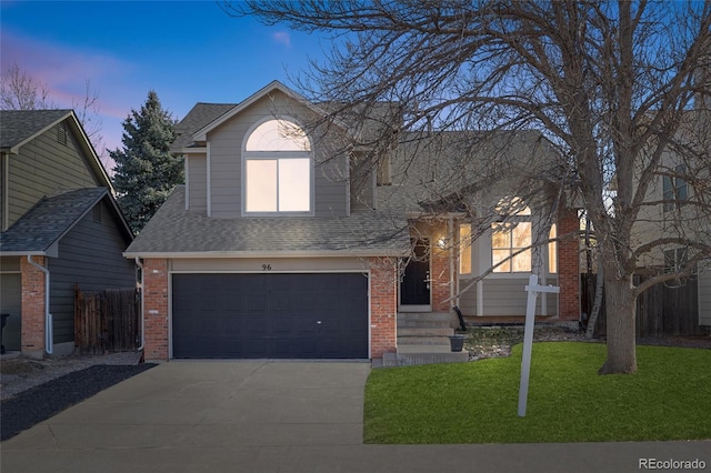 view of front of property with a garage, a front yard, brick siding, and driveway