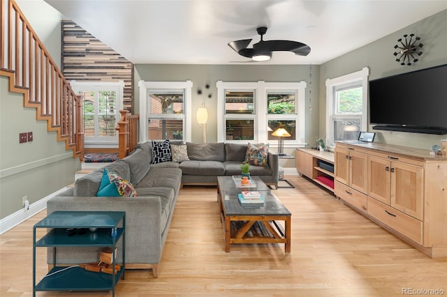 1121 S Williams St, Denver, CO 80210 - living room featuring a ceiling fan, light wood finished floors, and stairs