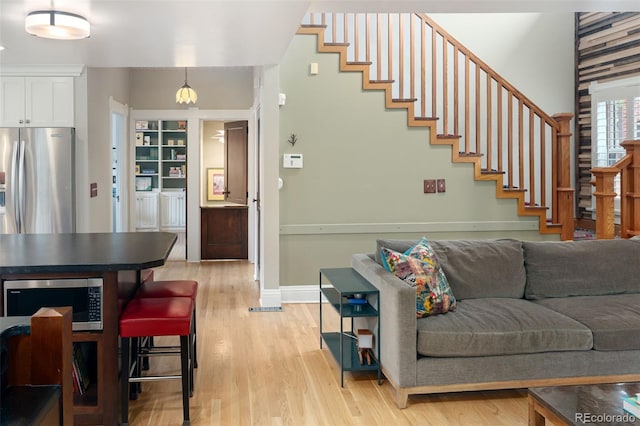 1121 S Williams St, Denver, CO 80210 - living room featuring light wood finished floors and stairs