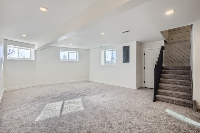 basement featuring electric panel and light carpet