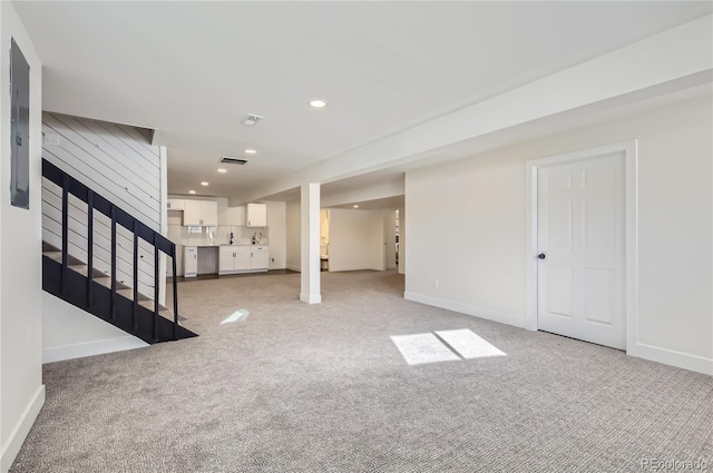 basement featuring light colored carpet