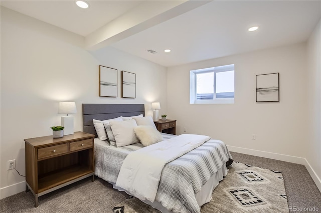 carpeted bedroom with beam ceiling