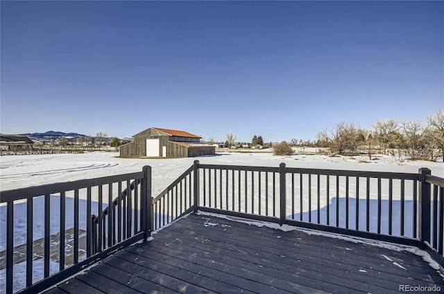 snow covered deck with a storage shed