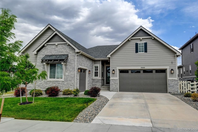 7000 S White Crow Way, Aurora, CO 80016 - view of front of home with a garage, a front yard, concrete driveway, and stone siding