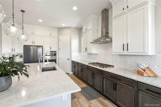 7000 S White Crow Way, Aurora, CO 80016 - kitchen featuring white cabinets, wall chimney exhaust hood, dark brown cabinets, backsplash, and recessed lighting