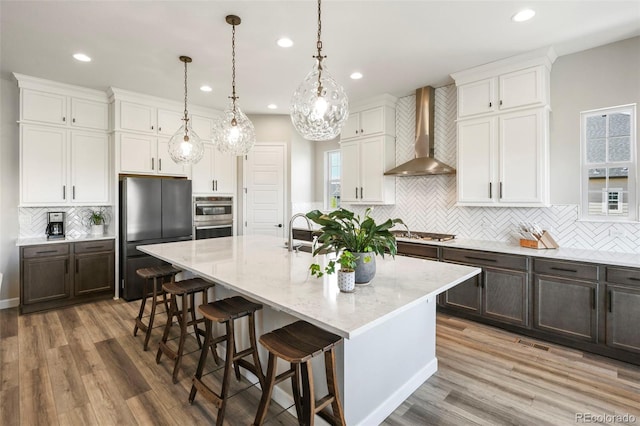 7000 S White Crow Way, Aurora, CO 80016 - kitchen featuring backsplash, recessed lighting, stainless steel appliances, white cabinets, and an island with sink
