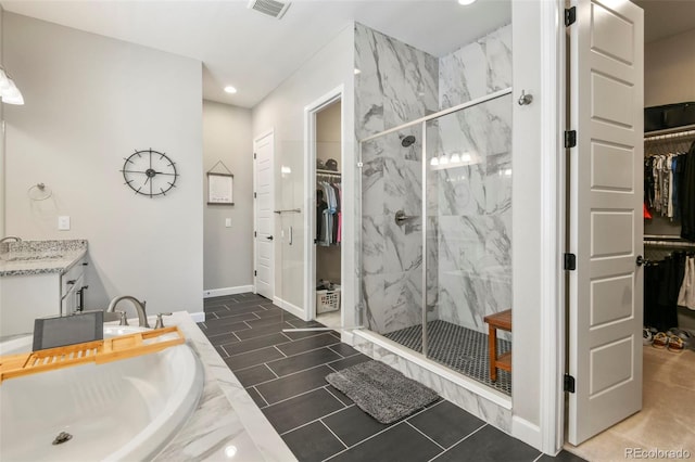 7000 S White Crow Way, Aurora, CO 80016 - full bathroom with vanity, a walk in closet, a marble finish shower, and recessed lighting
