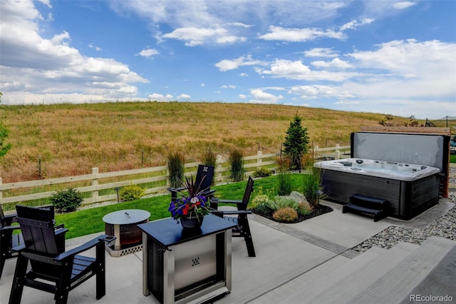 7000 S White Crow Way, Aurora, CO 80016 - fenced backyard with a hot tub, a patio area, and a view of countryside