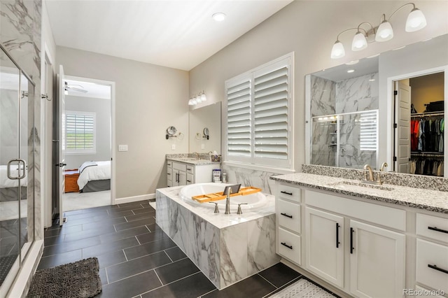 7000 S White Crow Way, Aurora, CO 80016 - full bath with a marble finish shower, two vanities, a bath, and tile patterned flooring
