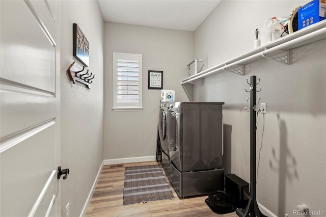7000 S White Crow Way, Aurora, CO 80016 - laundry room with washing machine and clothes dryer and wood finished floors