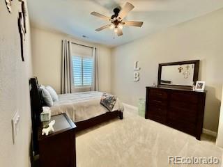 7000 S White Crow Way, Aurora, CO 80016 - carpeted bedroom with baseboards and ceiling fan