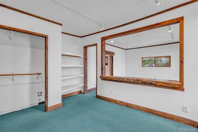 interior space featuring a textured ceiling and crown molding