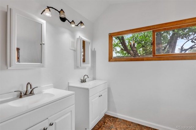 bathroom featuring vanity and vaulted ceiling