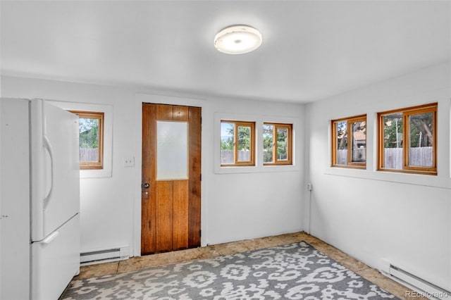 interior space with baseboard heating and plenty of natural light