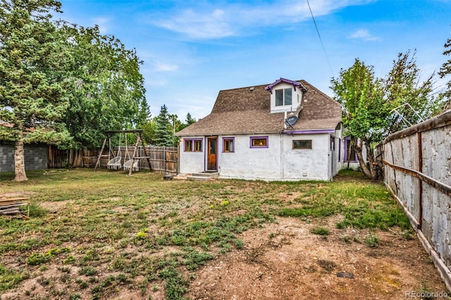 back of property with a lawn