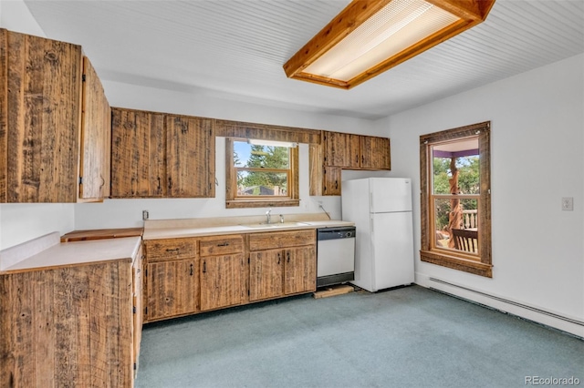 kitchen featuring light colored carpet, sink, white appliances, and a wealth of natural light