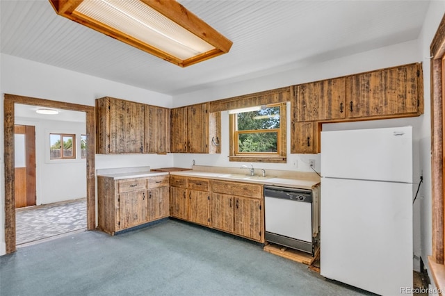 kitchen featuring light carpet, white appliances, and a wealth of natural light