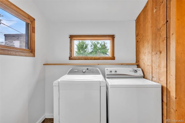 laundry room featuring washing machine and dryer and plenty of natural light