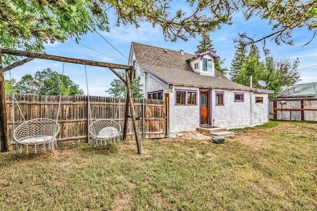 rear view of property with a yard