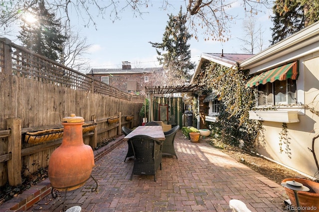 view of patio / terrace featuring outdoor dining area and fence