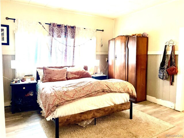 941 French St, Silver Cliff, CO 81252 - bedroom with wood finished floors and wainscoting
