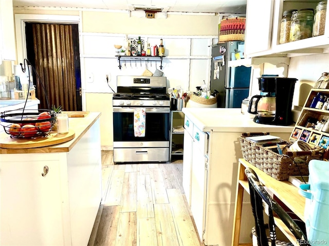 941 French St, Silver Cliff, CO 81252 - kitchen with stainless steel appliances, light wood-style floors, light countertops, and white cabinetry