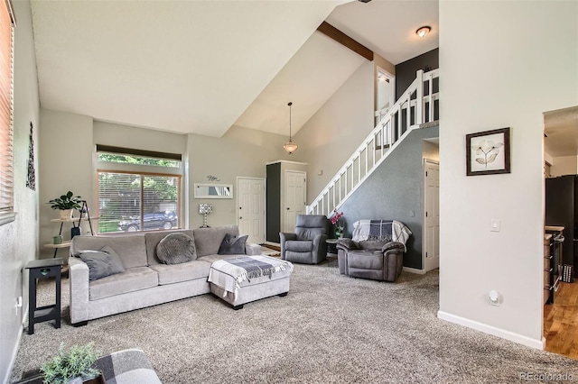 12013 W 56th Cir, Arvada, CO 80002 - carpeted living room featuring high vaulted ceiling and stairs