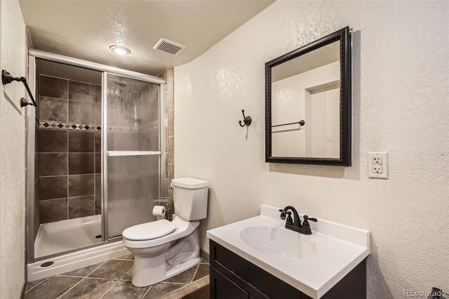 12013 W 56th Cir, Arvada, CO 80002 - full bathroom featuring a textured wall, vanity, a shower stall, and tile patterned floors