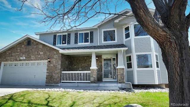 view of front of property with concrete driveway, stone siding, an attached garage, and covered porch