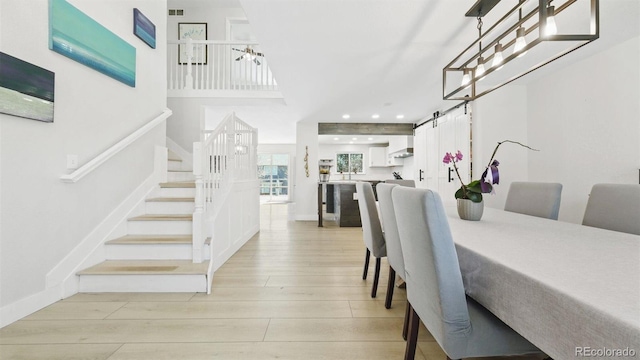 dining room featuring light wood-type flooring, visible vents, recessed lighting, stairs, and baseboards