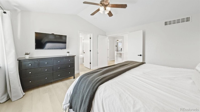 bedroom with visible vents, ensuite bathroom, a ceiling fan, light wood-style floors, and lofted ceiling