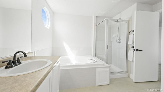 full bathroom with tile patterned floors, a shower stall, vanity, and a garden tub
