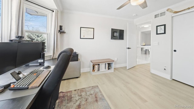 office space with crown molding, ceiling fan, visible vents, wood finished floors, and baseboards