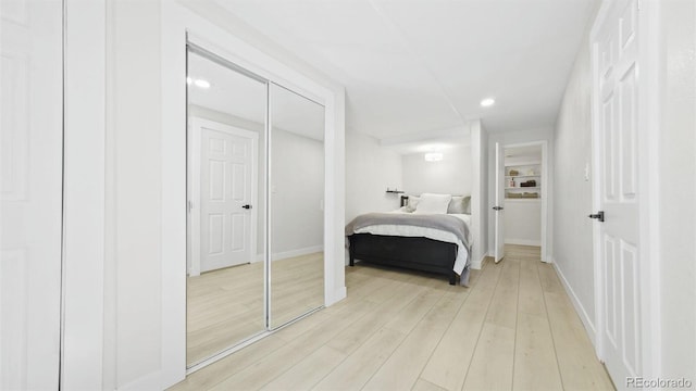 bedroom featuring recessed lighting, light wood-type flooring, and baseboards