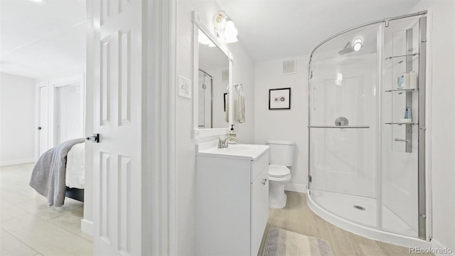 full bath with vanity, baseboards, toilet, a shower stall, and visible vents