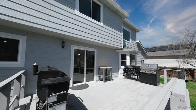 wooden deck with grilling area and fence