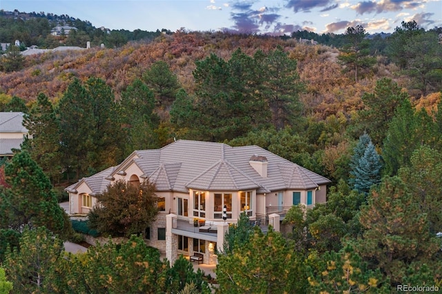 birds eye view of property with a view of trees