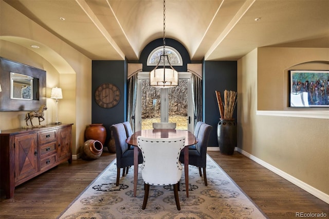 dining area with vaulted ceiling, baseboards, and dark wood finished floors