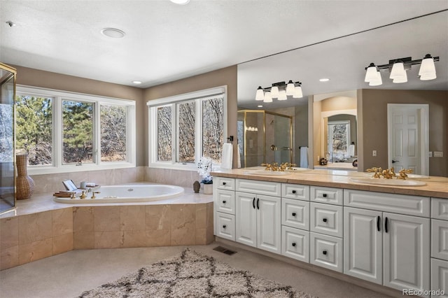 full bathroom featuring a garden tub, a sink, a shower stall, and double vanity