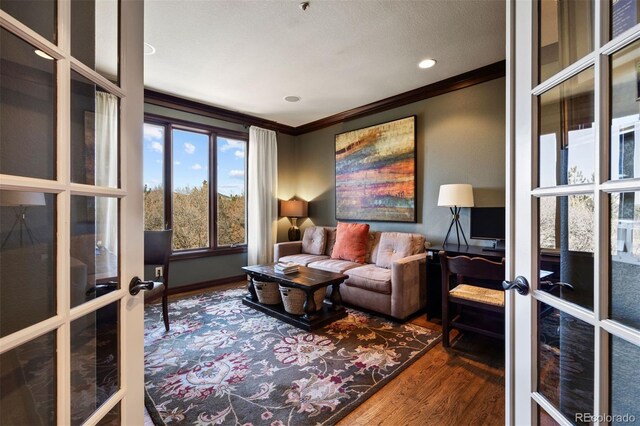 interior space featuring french doors, crown molding, and wood finished floors