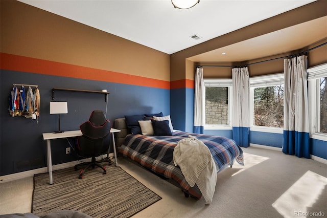 bedroom with carpet, visible vents, and baseboards