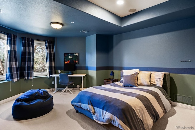 carpeted bedroom with baseboards, visible vents, and a textured ceiling