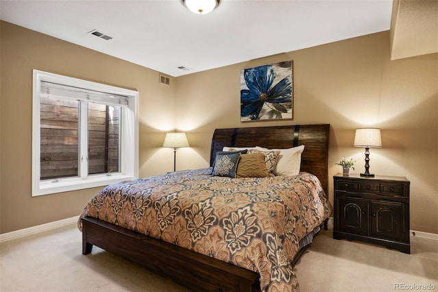 bedroom featuring carpet floors, visible vents, and baseboards