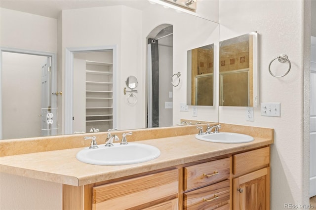 bathroom with vanity and a shower with shower door