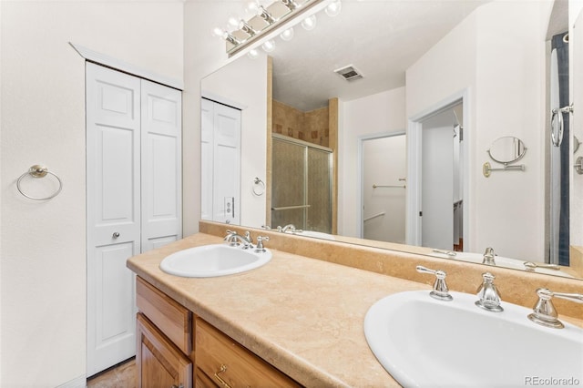 bathroom with vanity and an enclosed shower