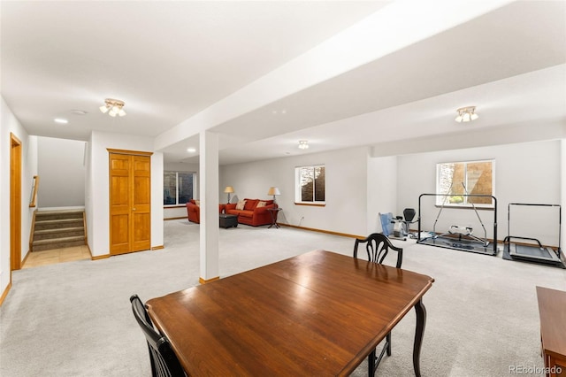 dining room with light carpet and a healthy amount of sunlight