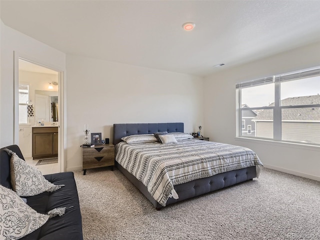 4955 Trails Edge Ln, Castle Rock, CO 80104 - bedroom with light carpet, baseboards, multiple windows, and connected bathroom
