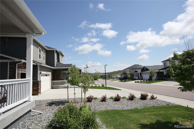 4955 Trails Edge Ln, Castle Rock, CO 80104 - view of yard featuring a residential view, concrete driveway, a garage, and a porch